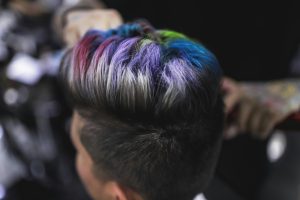 Close-up of a stylish multi-colored hairstyle showing vibrant rainbow hues, capturing modern hair artistry.